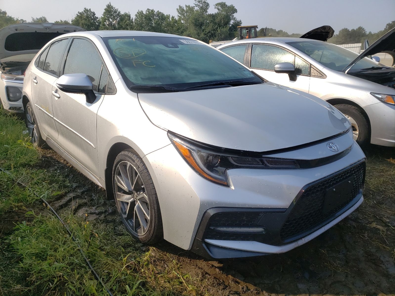 Front three-quarter view of a silver Toyota Corolla sedan at an outdoor auction lot